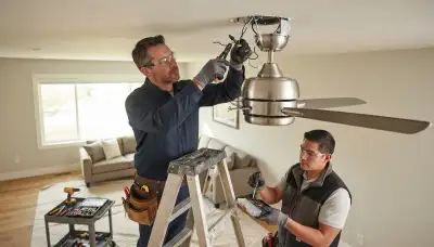 Electrician installing ceiling fan wiring in an Aurora, Colorado home