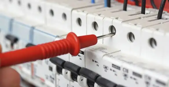 Electrical contractor testing circuit breakers during electrical repair in Englewood, CO
