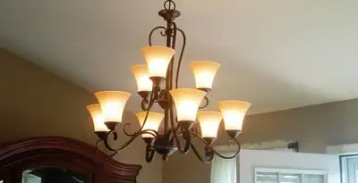 Classic ceiling chandelier installation with warm lighting in Aurora, CO