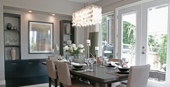 Elegant dining room chandelier installation above table in Aurora, CO