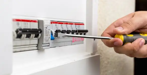 electrical panel upgrade service showing technician adjusting circuit breakers during system upgrade in Aurora, CO