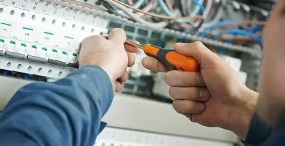 electrical service showing licensed electrician performing electrical panel maintenance and adjustments in Aurora, CO