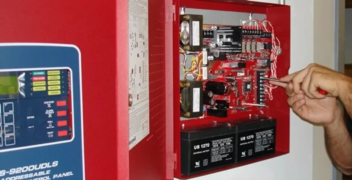 fire alarm installation service showing technician configuring fire alarm control panel in Aurora, CO