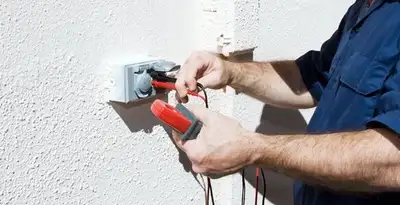 Electrician performing home electrical outlet and wiring inspection in Aurora, CO