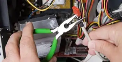 Licensed electrical contractor performing electrical repair with tools in Parker, CO
