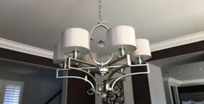 Modern chandelier installation with multiple light fixtures in Aurora, CO