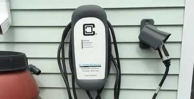 Outdoor electric vehicle charger installation on residential wall in Aurora, CO