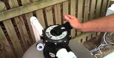 pool pumps service showing professional adjustment of pool pump control system in Aurora, CO