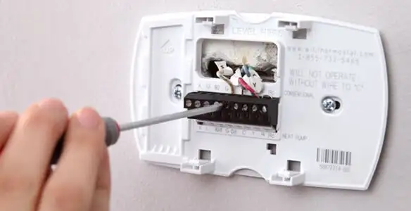Thermostat installation service with proper wiring and secure wall mounting in Aurora, CO