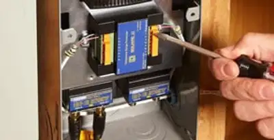 Whole home surge protection device being installed by a licensed electrician to protect electrical systems in Aurora, CO